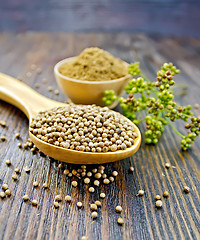 Image showing Coriander in bowl and spoon on board