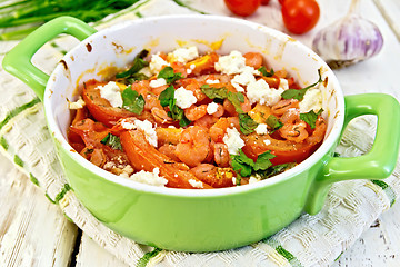 Image showing Shrimp and tomatoes with feta in pan on board