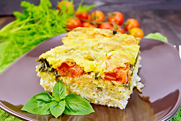 Image showing Pie potato with tomato and cheese on dark board