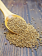 Image showing Coriander seeds in spoon on board