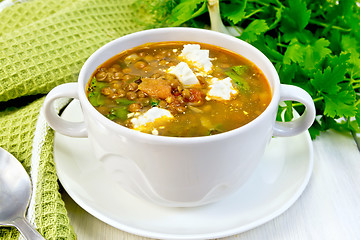 Image showing Soup lentil with spinach and cheese on board