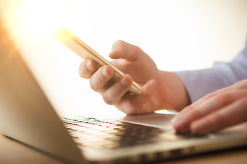 Image showing The male hand holding a phone 