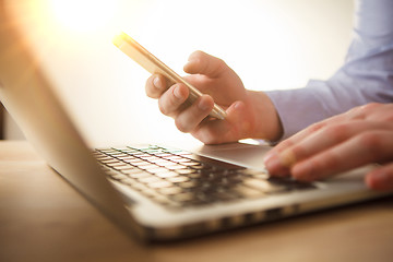 Image showing The male hand holding a phone 