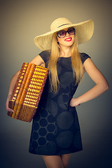 Image showing The traveler woman standing with retro suitcase 