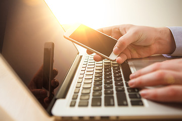 Image showing The male hand holding a phone 