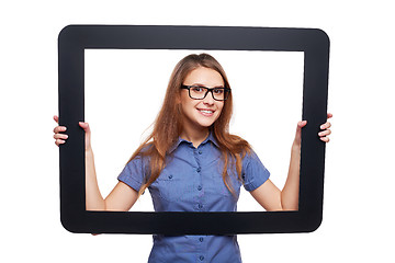 Image showing Smiling female peeping out of tablet frame