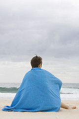 Image showing woman with blue blanket on beach