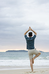 Image showing Man doing yoga on beach