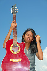 Image showing Asian teen with guitar