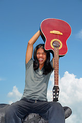 Image showing Asian cheering with guitar