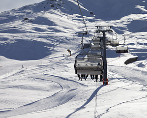 Image showing Chair-lift and ski slope at sun evening