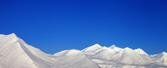 Image showing Panoramic view of snowy mountains and blue clear sky