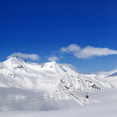 Image showing Winter snowy mountains and ski slope at nice day.