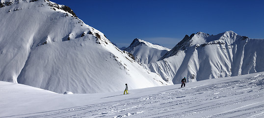 Image showing Panoramic view of snowboarders downhill on off piste slope after