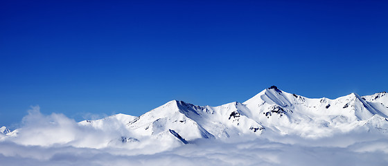 Image showing Panoramic view of winter snowy mountains under clouds at nice da