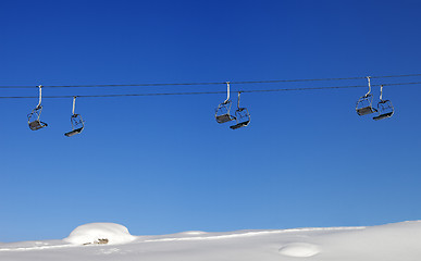 Image showing Chair-lift and blue clear sky at sun day