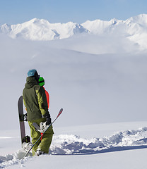 Image showing Snowboarders on off-piste slope after snowfall