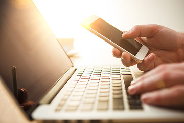 Image showing The male hand holding a phone 