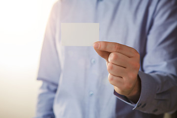 Image showing Man holding white business card 