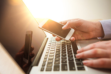 Image showing The male hand holding a phone 