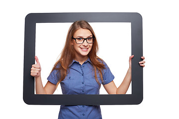 Image showing Surprised female peeping out of tablet frame