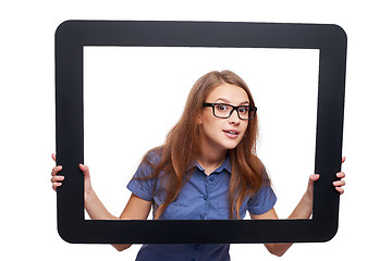 Image showing Surprised female peeping out of tablet frame