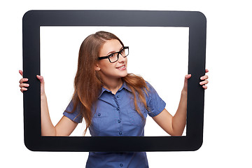 Image showing Surprised female peeping out of tablet frame