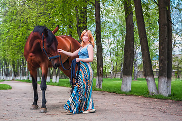 Image showing Young blond with a beautiful horse