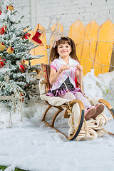 Image showing Little girl with gifts under the Christmas tree