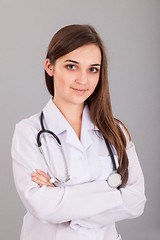 Image showing Young and beautiful nurse on a grey