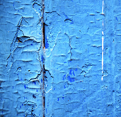 Image showing dirty stripped paint in the blue wood door and rusty nail