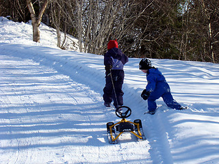 Image showing Children pulling ski bob