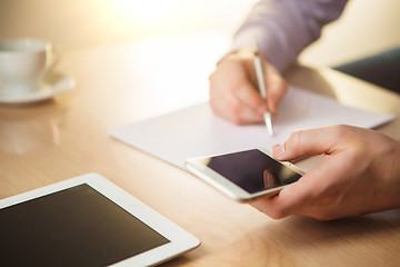 Image showing The male hand holding a phone 