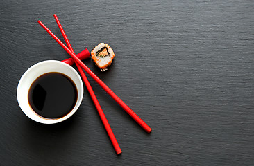 Image showing Soy sauce with red chopsticks