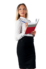 Image showing Pretty businesswoman standing with organizer diary