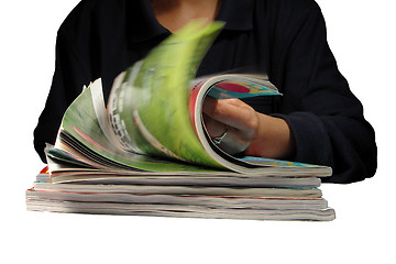Image showing Riffling through magazines