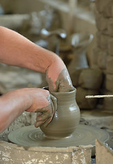 Image showing Artisan hands making clay pot