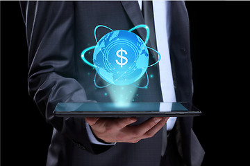 Image showing Businessman holding tablet with a projected on-screen icon online trading dollar. business Internet concept.