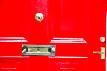 Image showing red handle in london antique door   