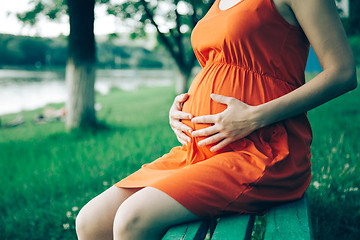 Image showing Pregnant woman, holding in hands bouquet of daisy 