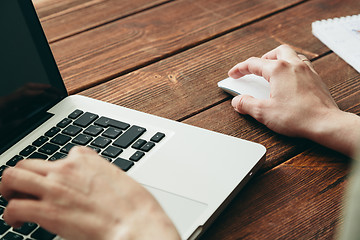 Image showing Close-up shot of laptop on old wooden desk