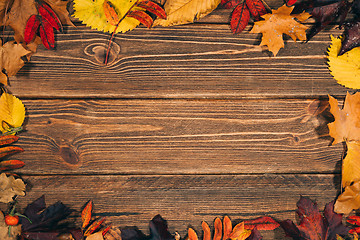 Image showing Background with wooden table and autumnal leaves