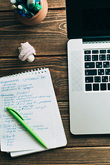 Image showing Workplace with open laptop on modern wooden desk 