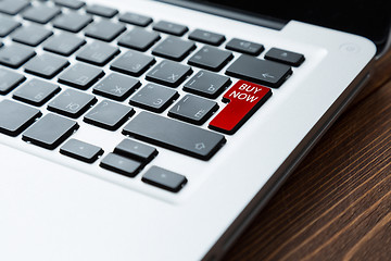 Image showing Red button buy now on a laptop