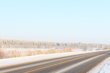 Image showing Winter road through snowy fields and forests