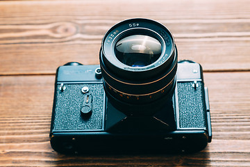 Image showing Old camera and on wooden table