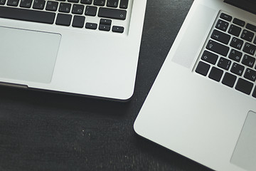 Image showing Two laptops on modern wooden desk 