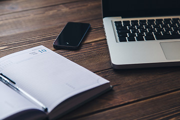 Image showing Laptop and diary on the desk