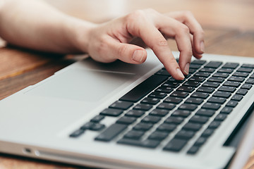 Image showing Close-up shot of laptop on old wooden desk