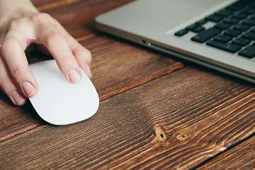 Image showing Close-up shot of laptop on old wooden desk